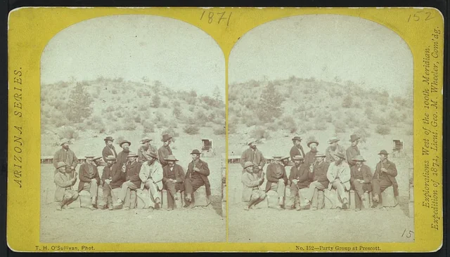 Paired stereograph views of a geographical survey party posing in Prescott in 1871