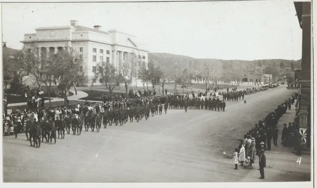 Parade passing the Yavapai County Courthouse and spectators around the plaza